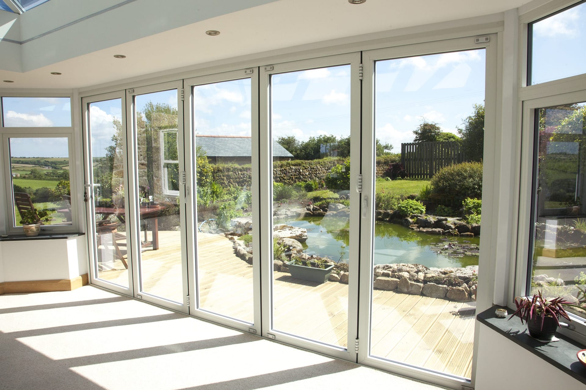 Large sliding patio doors in a Cornwall home overlooking a Cornish river