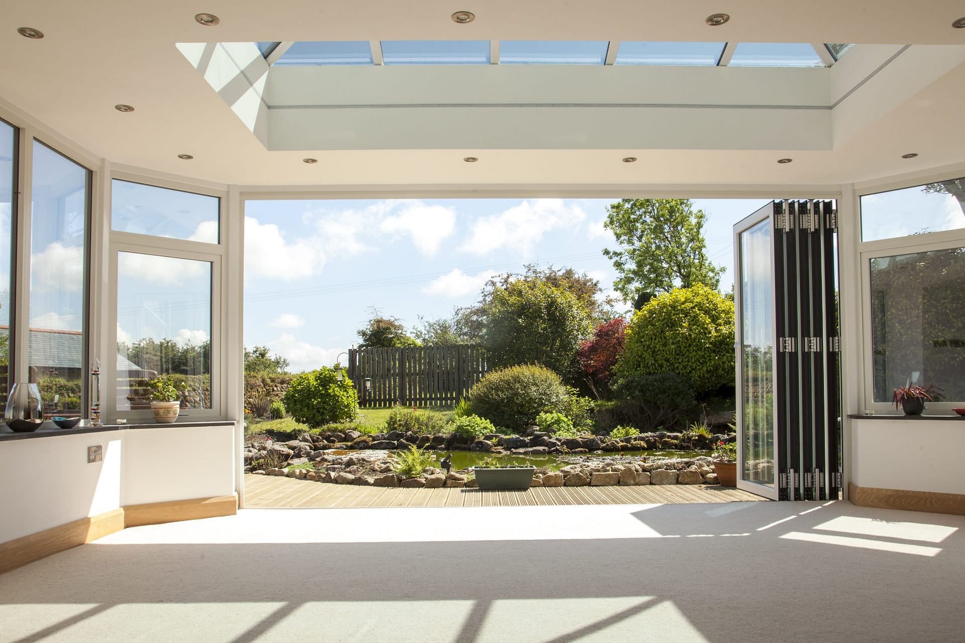 Aluminium bi-fold doors opening onto a patio and garden at a Cornwall home