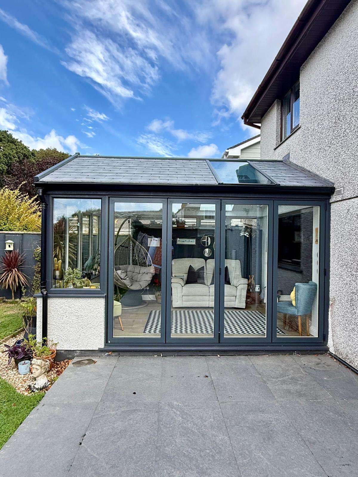 Front elevation of the garden room with anthracite-grey bifold doors closed.